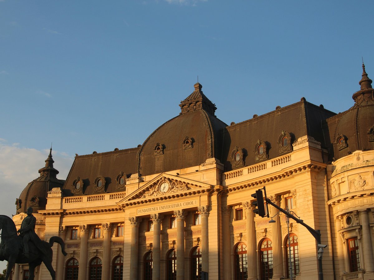 a large building with a statue in front of it