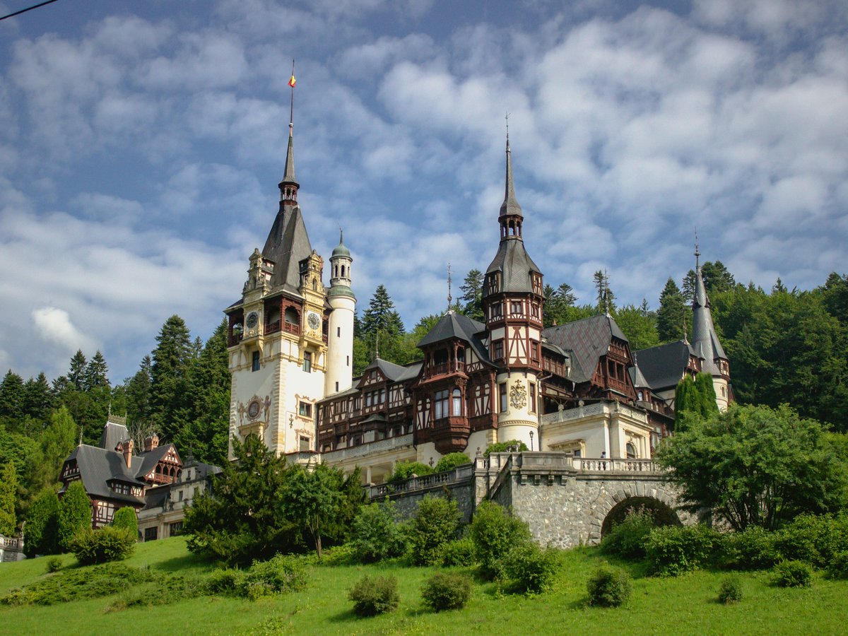 a large castle with towers on top of a hill