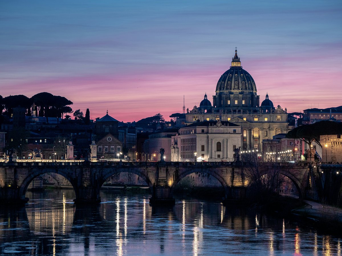 A view of a city with a bridge in the foreground