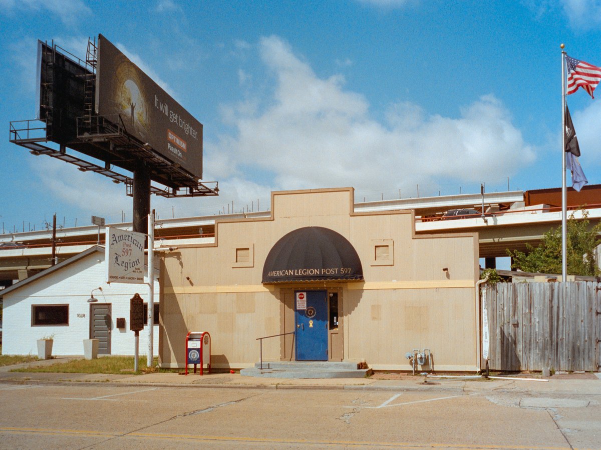 Building with arched entrance and large billboard