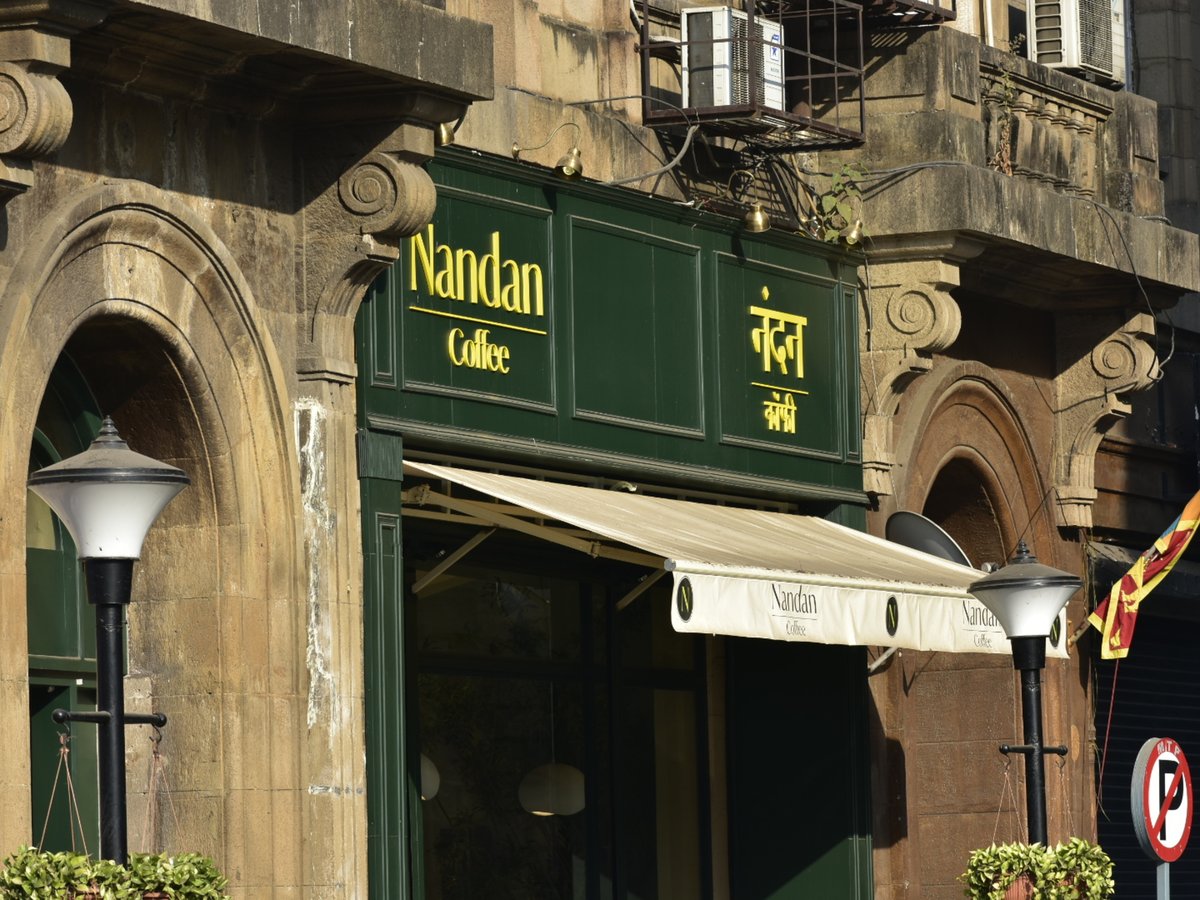 A street corner with a store front and a lamp post