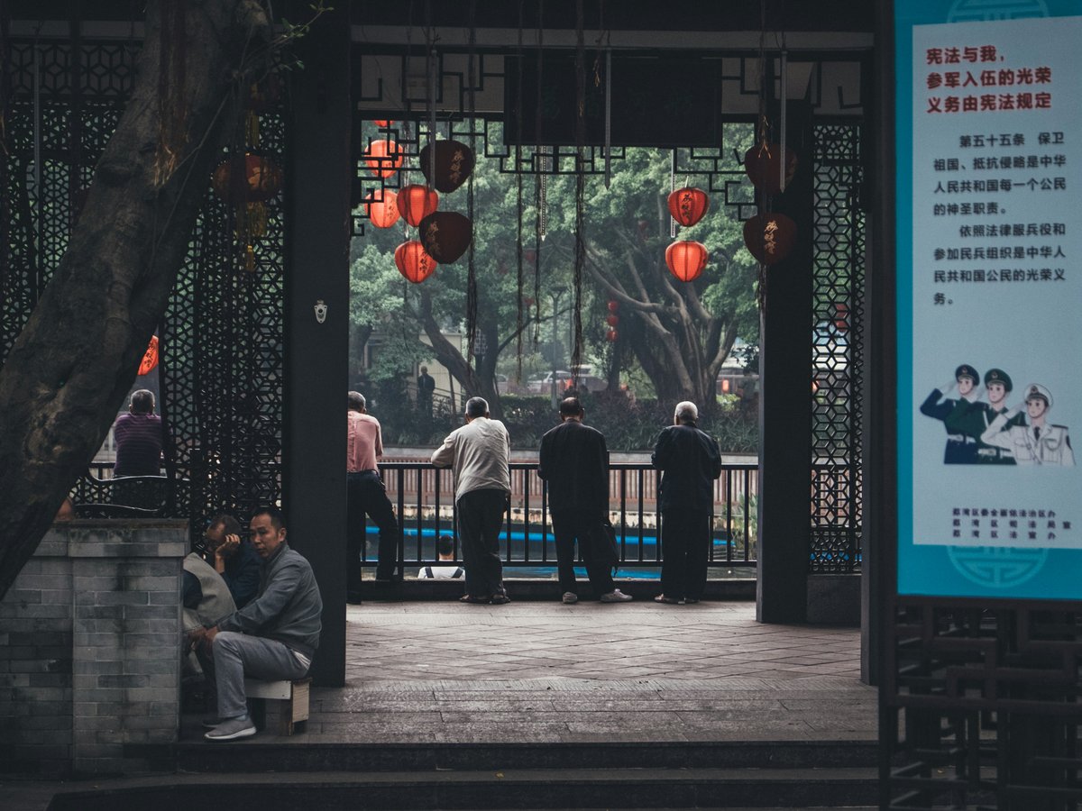 four person standing on balcony