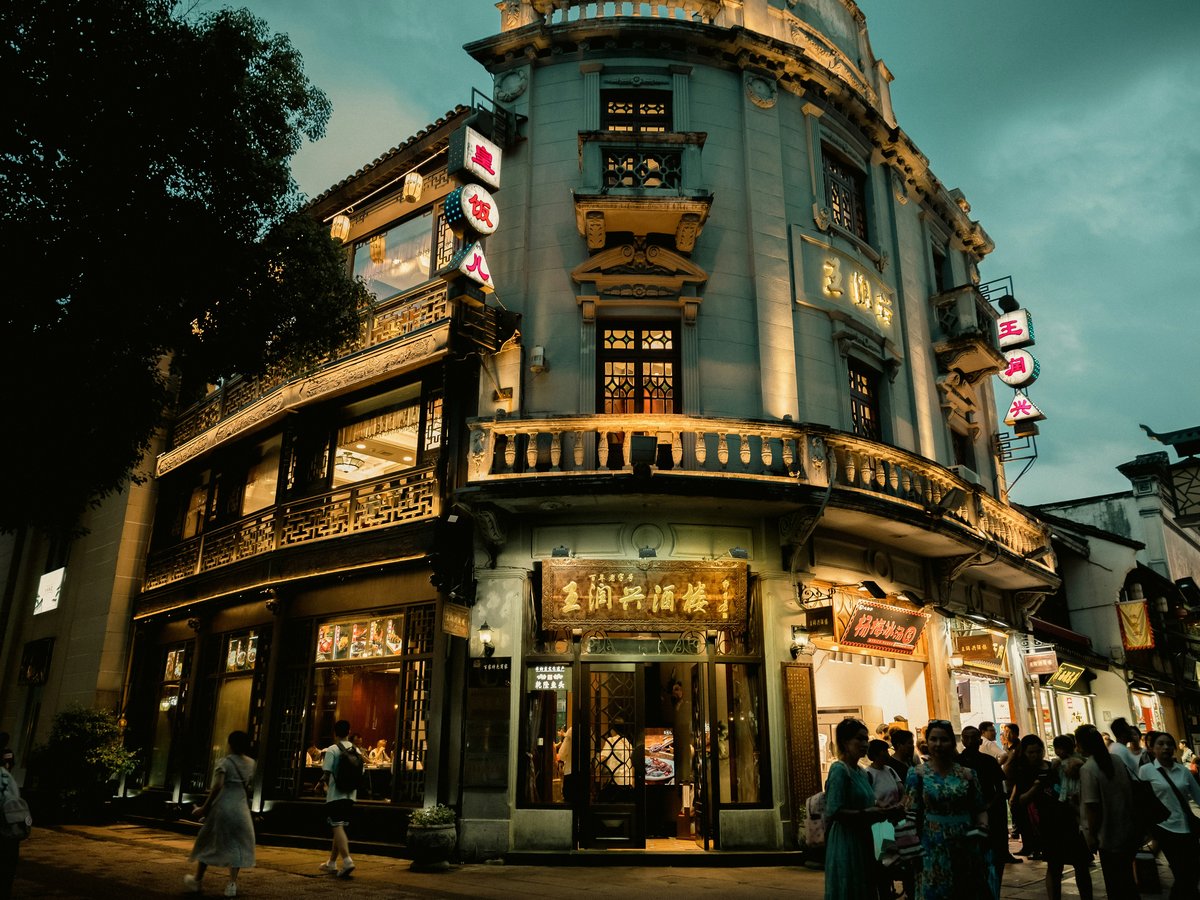 a group of people standing outside of a building