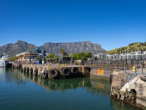 a large body of water with a mountain in the background