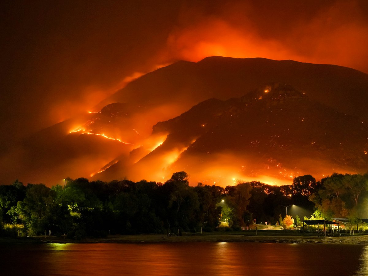 a large fire is burning in the mountains