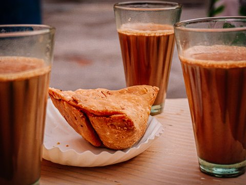 bread on white ceramic plate beside drinking glass