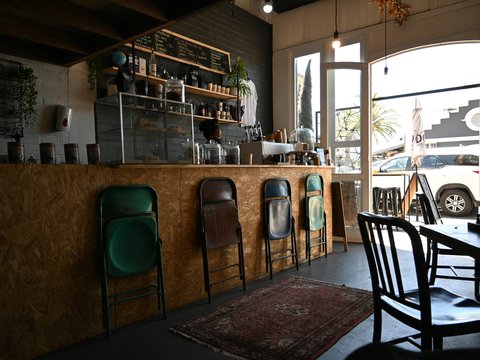 a restaurant with chairs and a counter