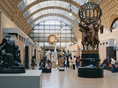 A group of people walking around a museum