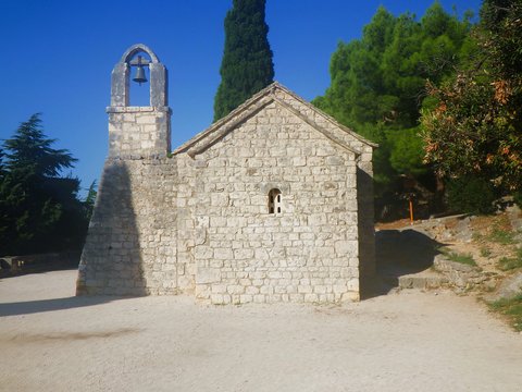 a stone building with a bell on top of it