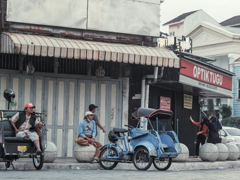 a group of people riding motorcycles down a street