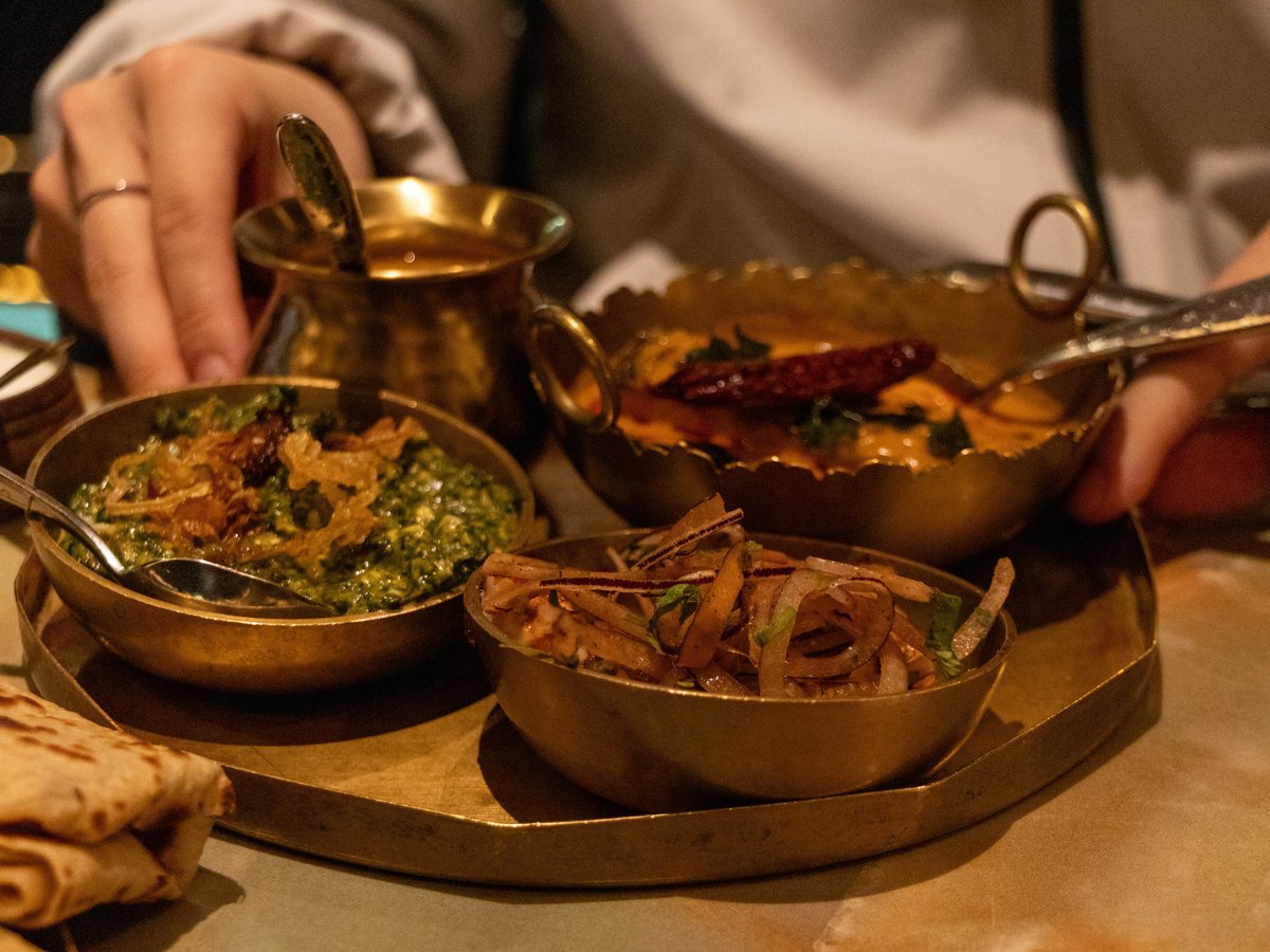 A person sitting at a table with a plate of food
