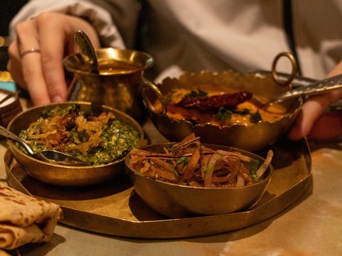 A person sitting at a table with a plate of food