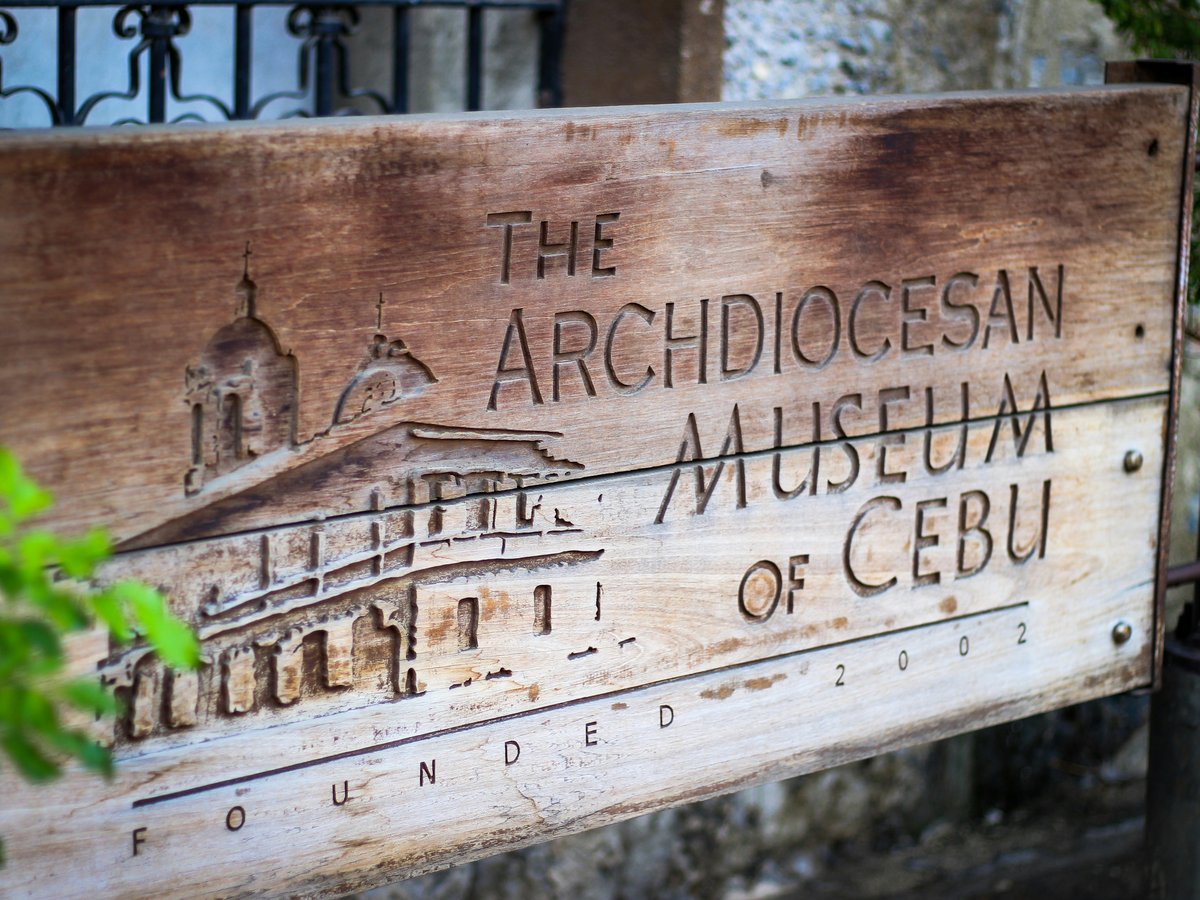 brown wooden signage with green plant