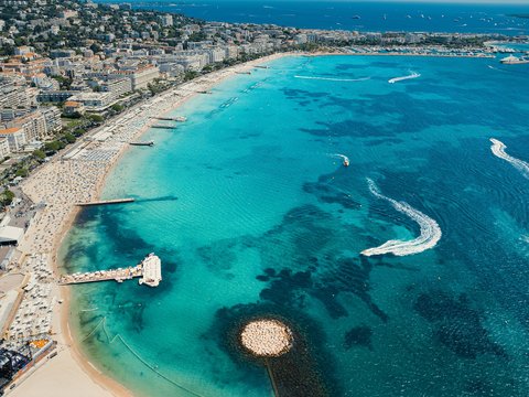 an aerial view of a beach with boats in the water