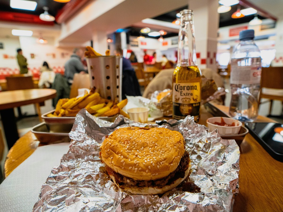 a hamburger sitting on top of a table covered in tin foil