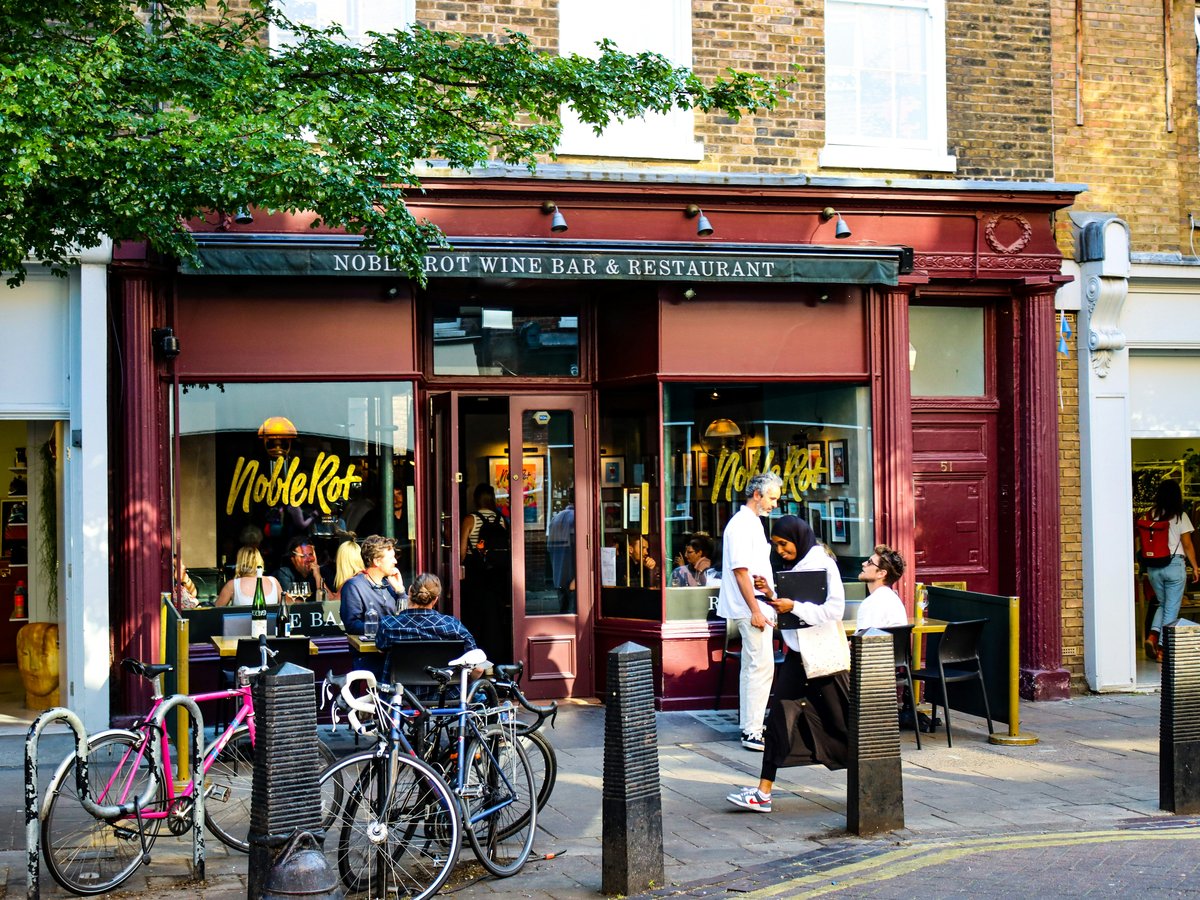 a group of people standing outside of a store