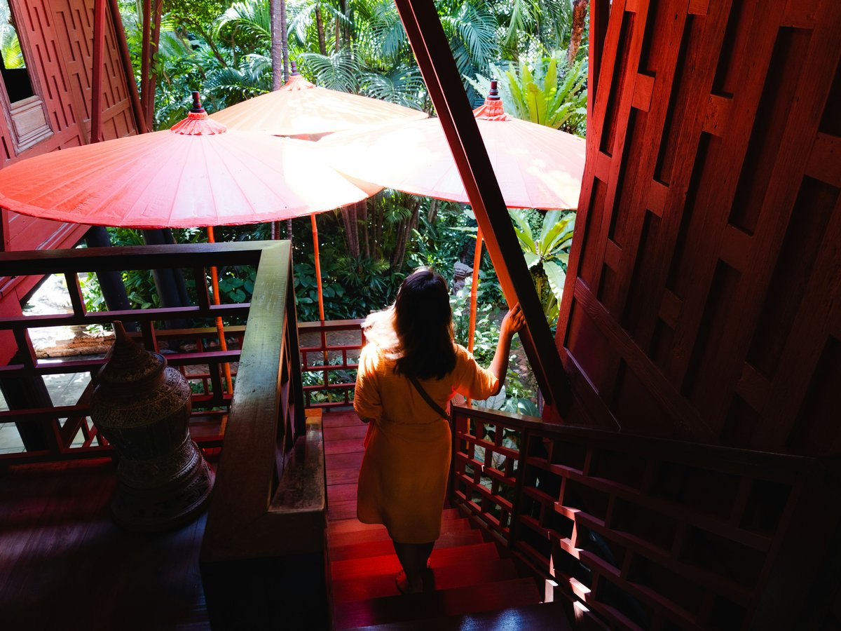 a woman in a yellow dress holding an umbrella