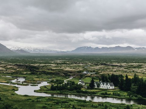 aerial photography of landscape farm under nimbus clouds