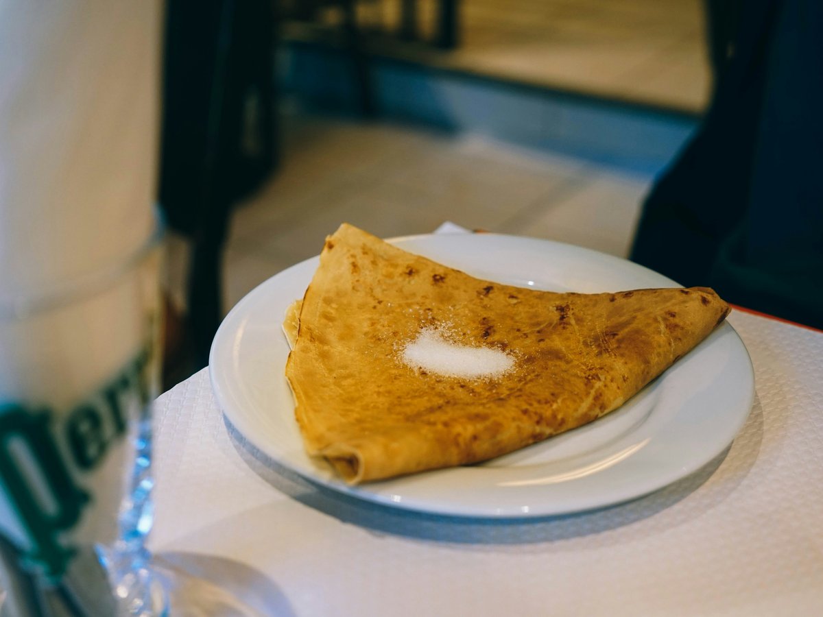 a white plate topped with a piece of food