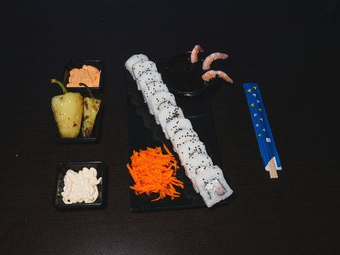 A black table topped with different types of sushi