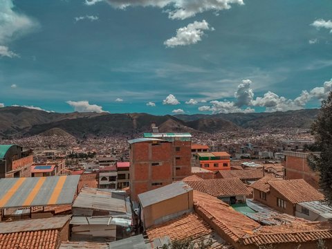 a city with many rooftops and mountains in the background