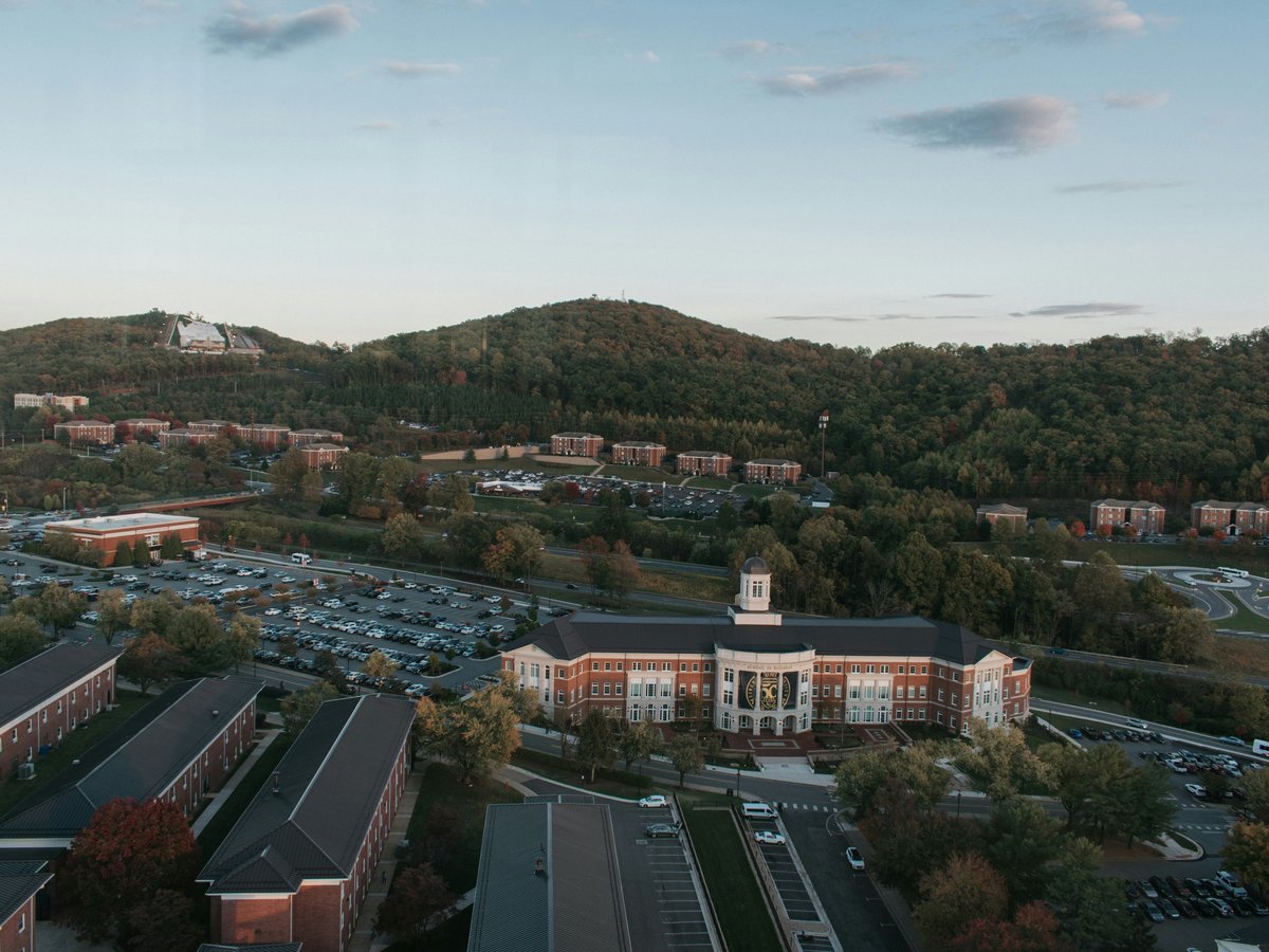 an aerial view of a college campus and parking lot