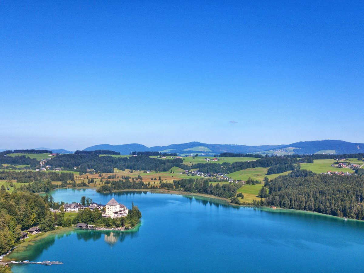 an aerial view of a lake surrounded by mountains