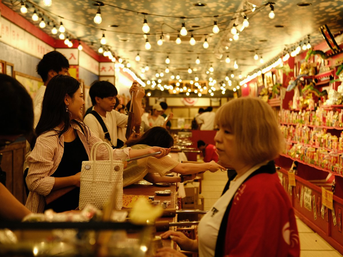 a group of people standing at a counter in a store