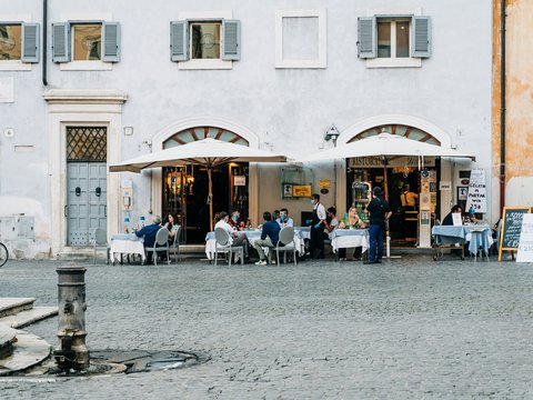 people sitting on chair near building during daytime