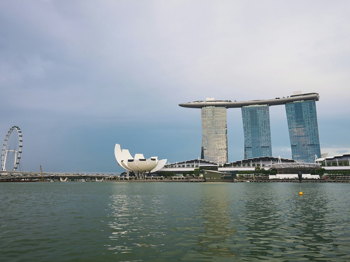 A body of water with a large building in the background