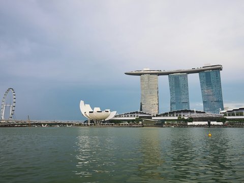 A body of water with a large building in the background