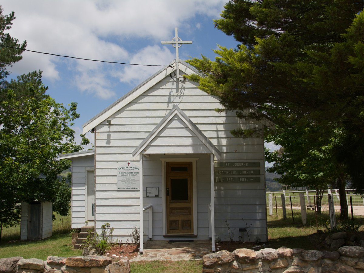 Small white chapel with a cross on top.