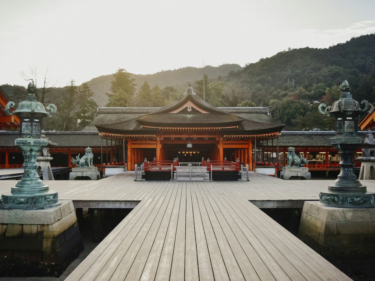 brown wooden gazebo near green trees during daytime