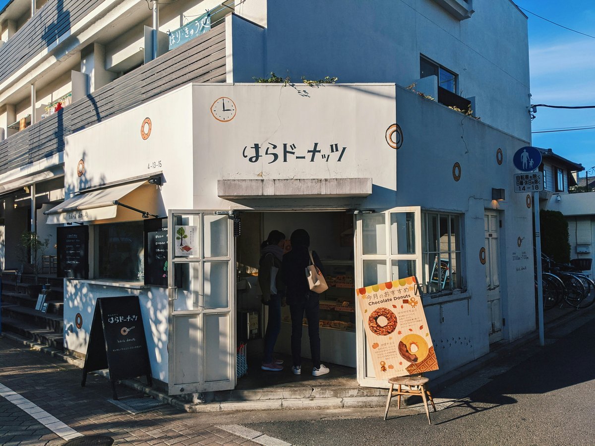 people standing in front of white and blue building during daytime