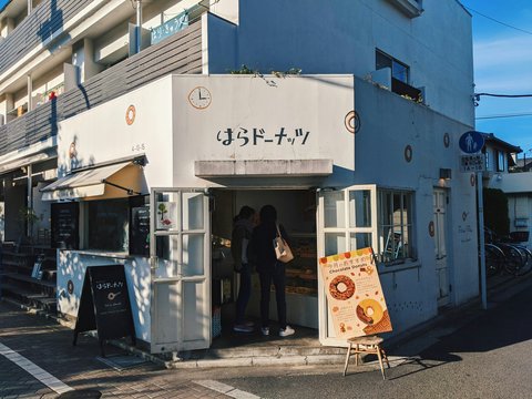 people standing in front of white and blue building during daytime