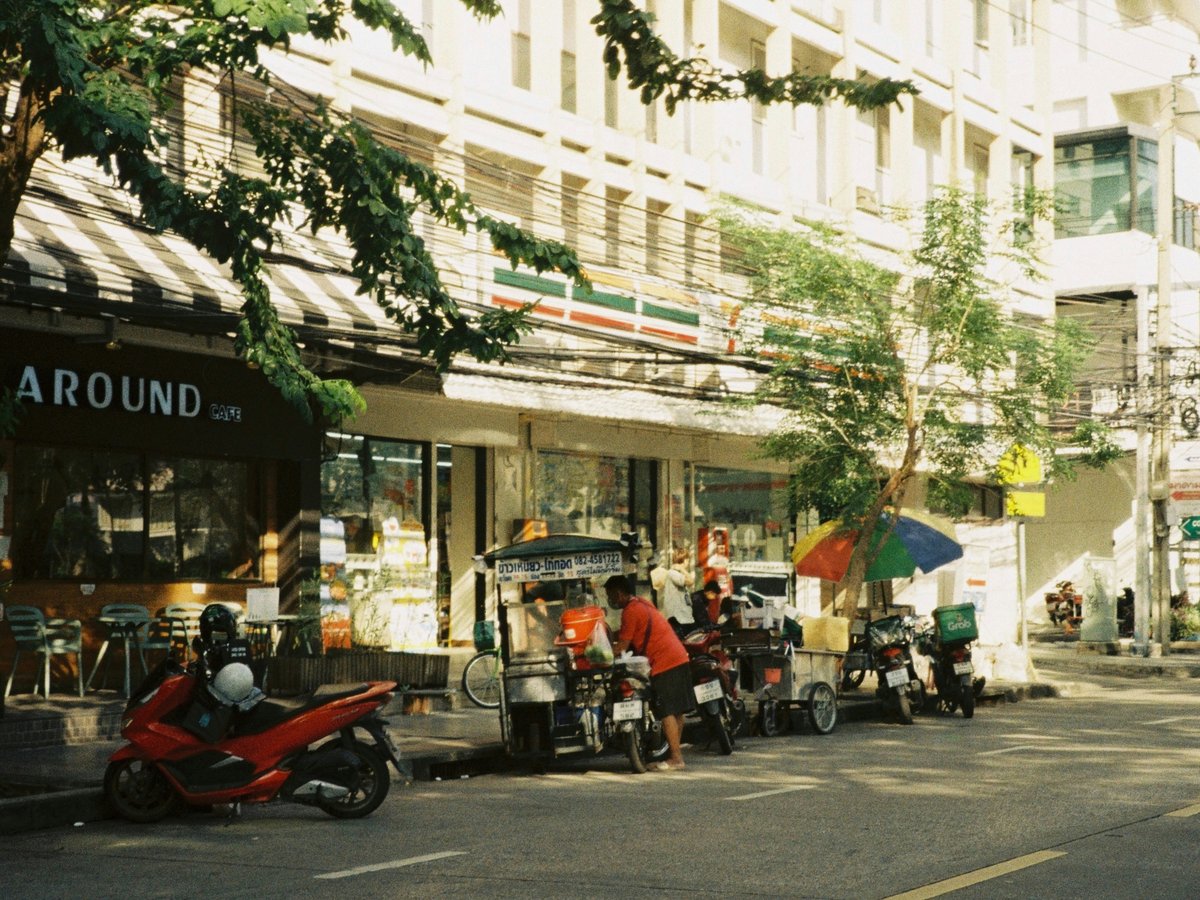A row of motorcycles parked on the side of a street