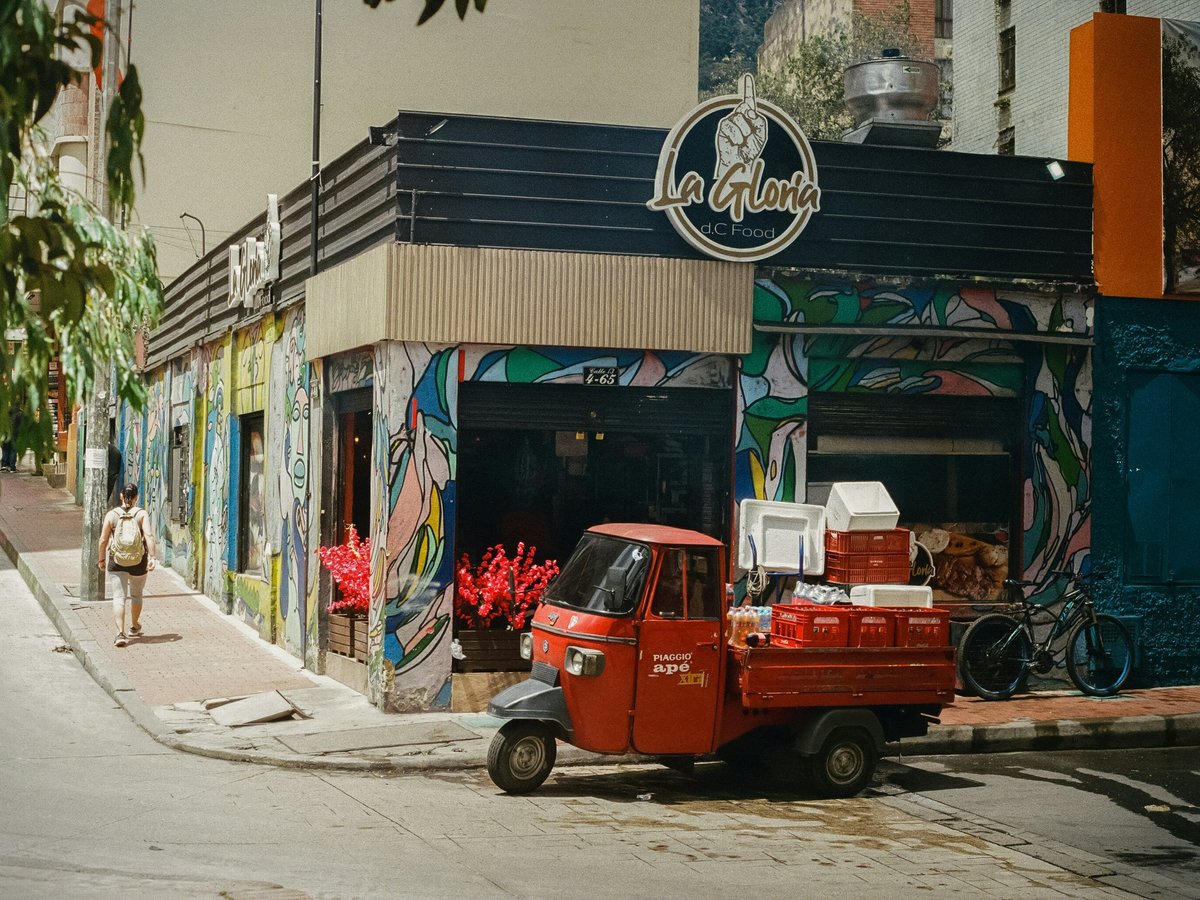 A red truck parked in front of a building