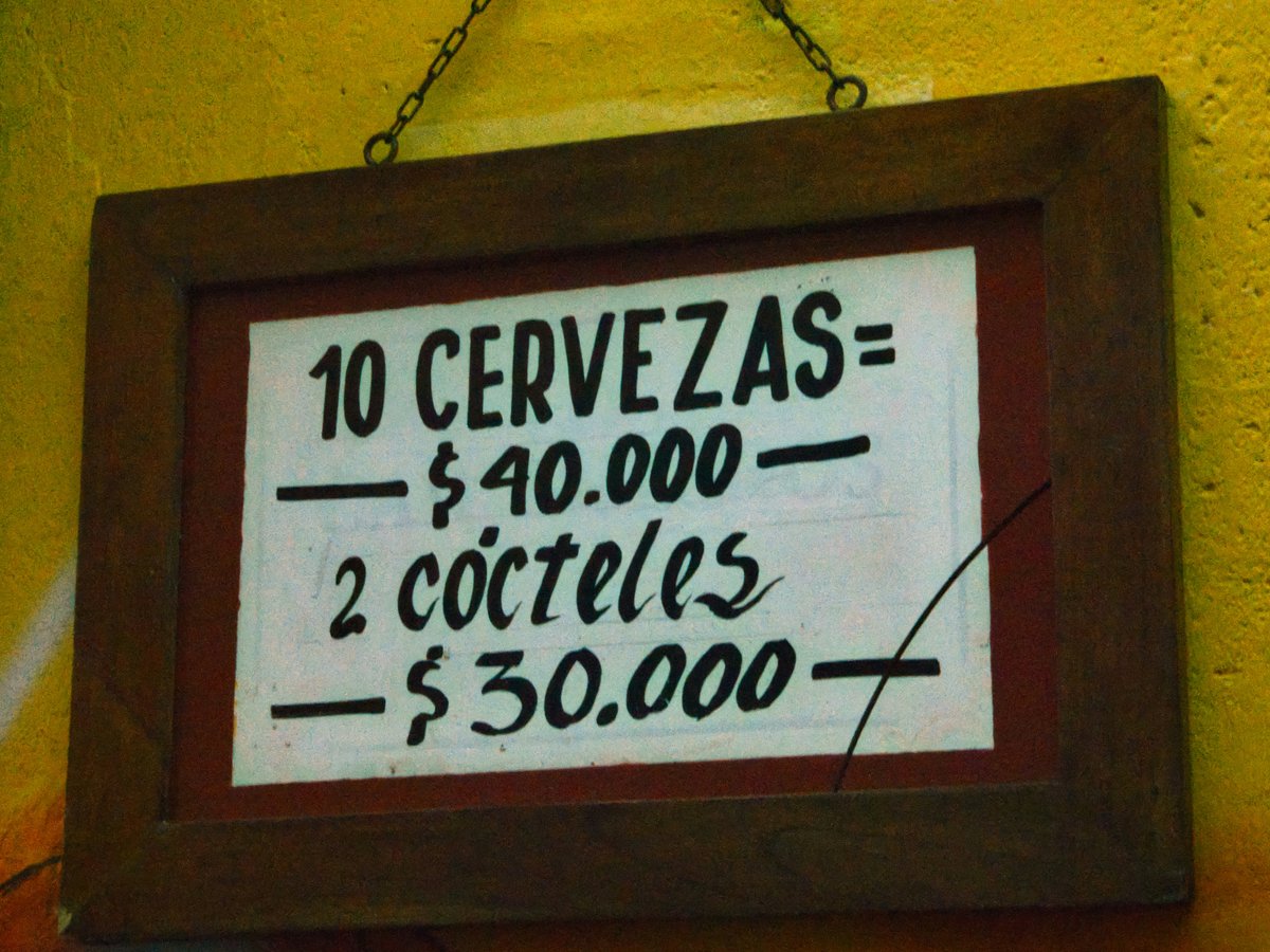 Sign lists prices for beers and cocktails