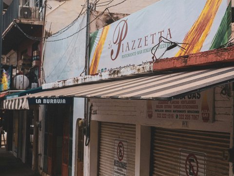 A piazza restaurant is visible along a closed street