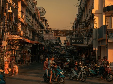 a group of people riding motorcycles down a street