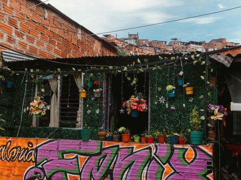 a building with a bunch of potted plants on top of it