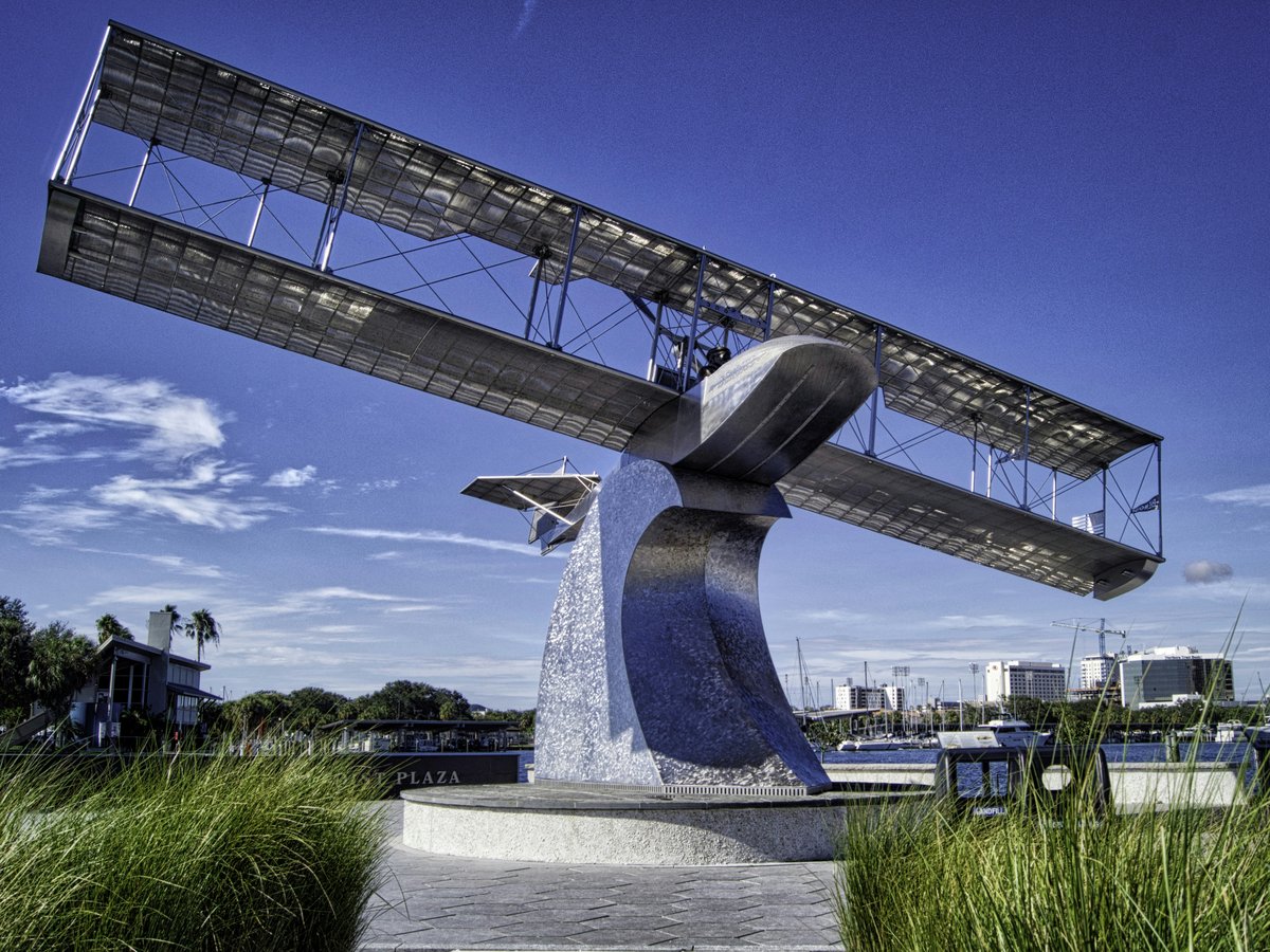 a sculpture of an airplane is in the grass