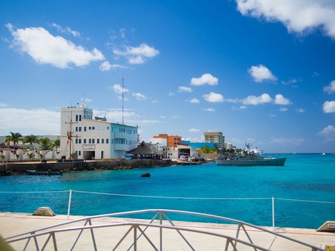 white and brown concrete building near body of water during daytime