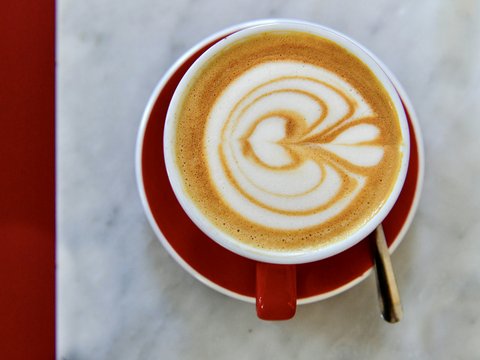 a cup of coffee with a swirl in it