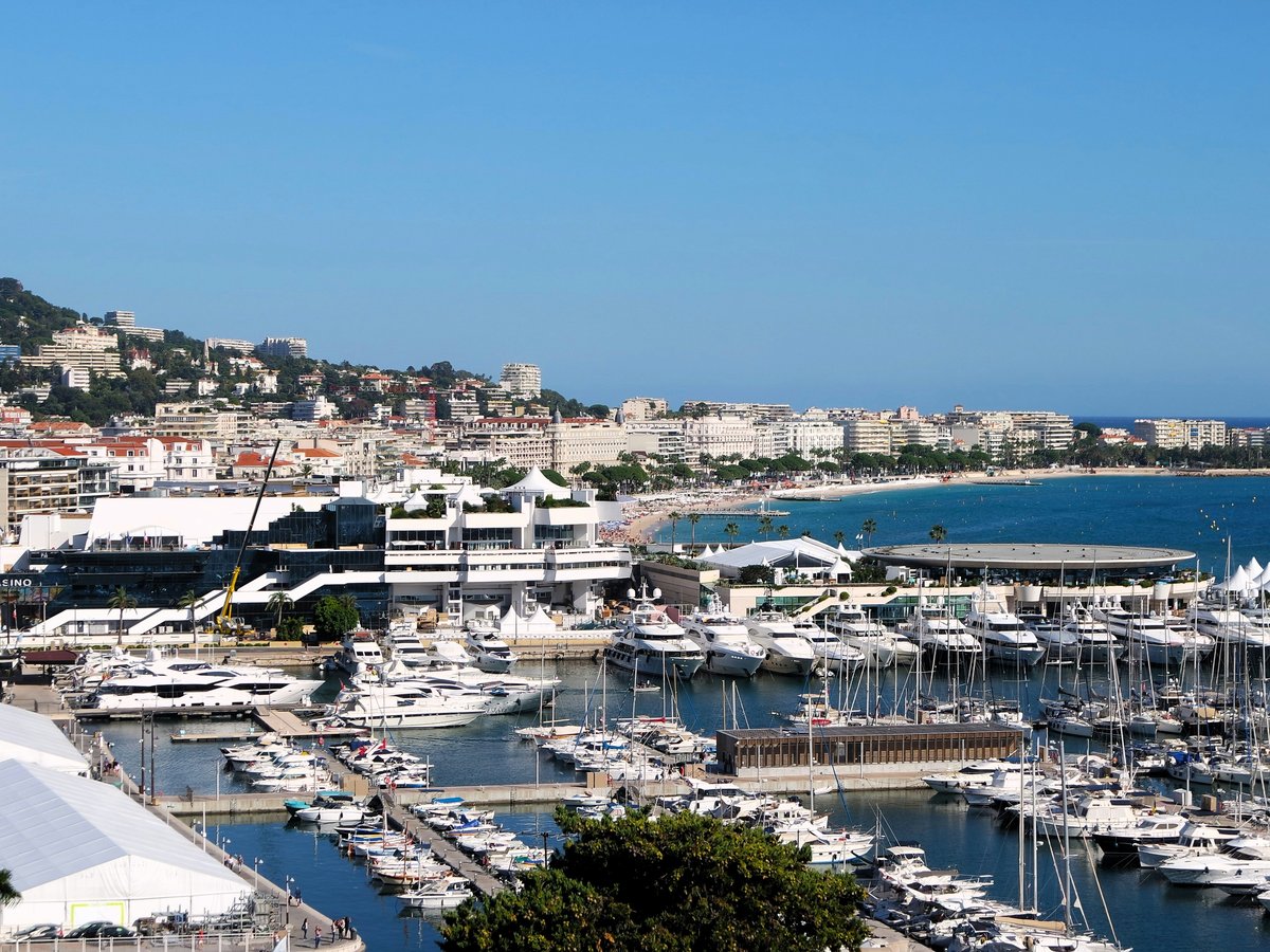a harbor filled with lots of boats next to a city