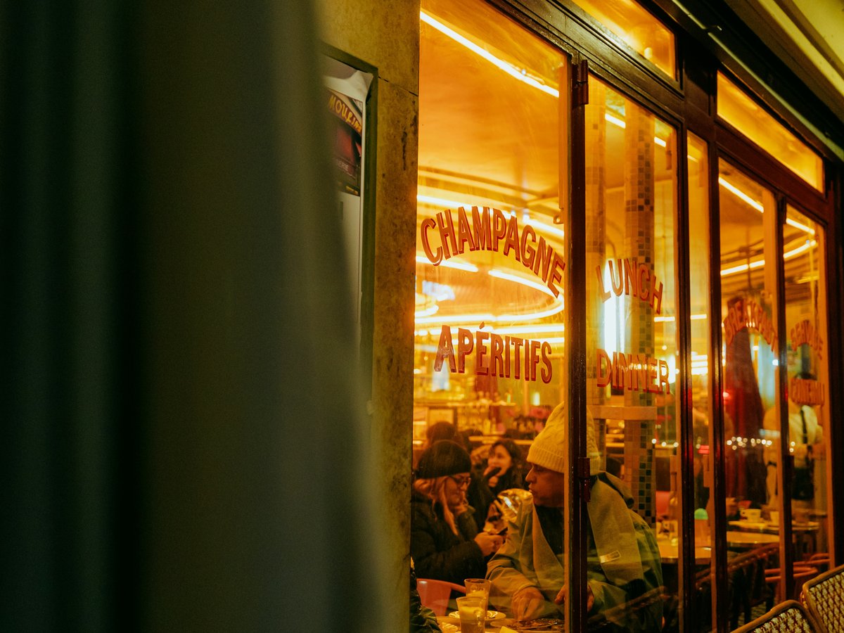 A store front with a lit up window at night