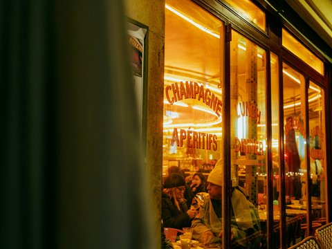 A store front with a lit up window at night