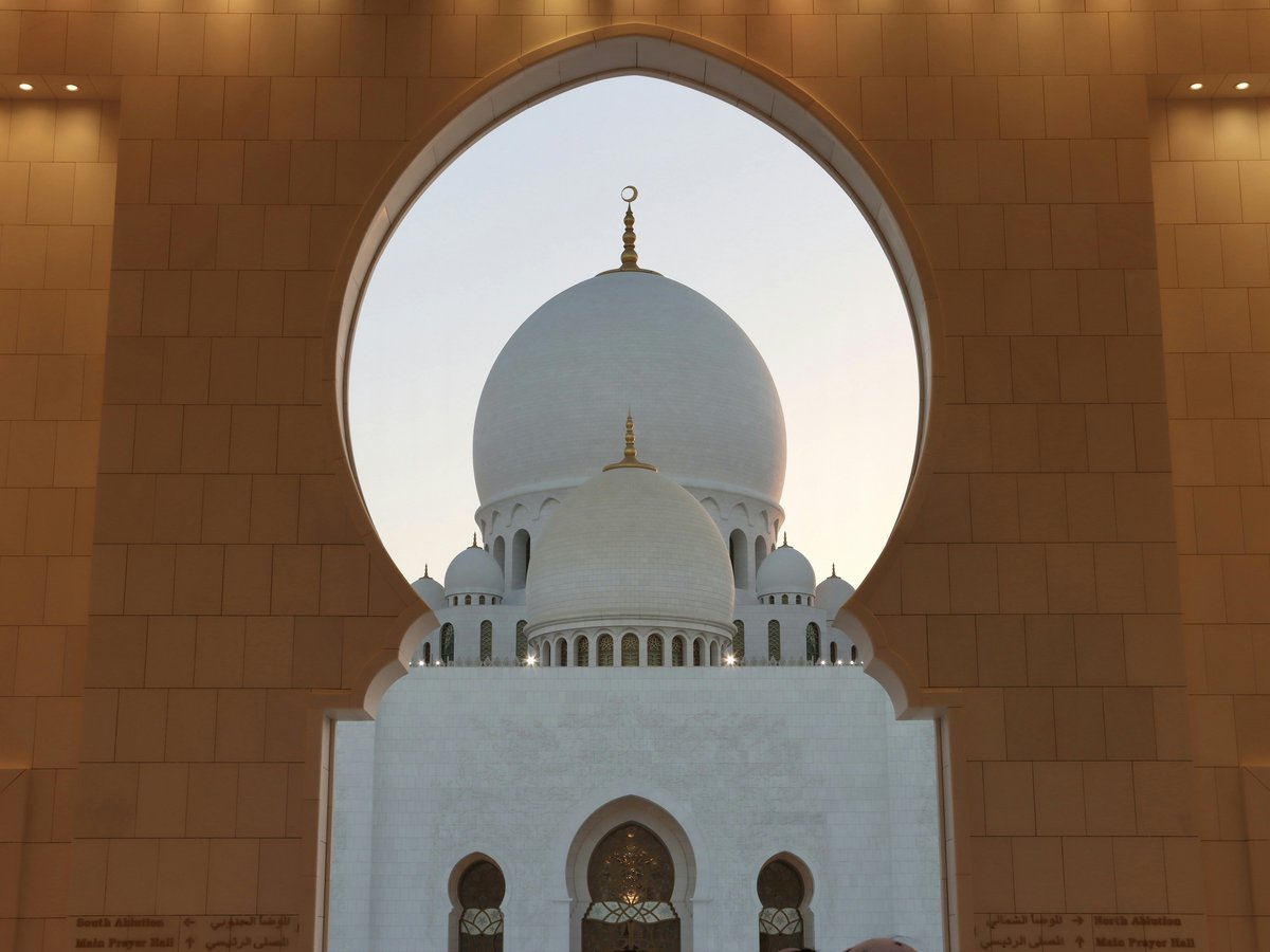A large white building with a dome on top of it