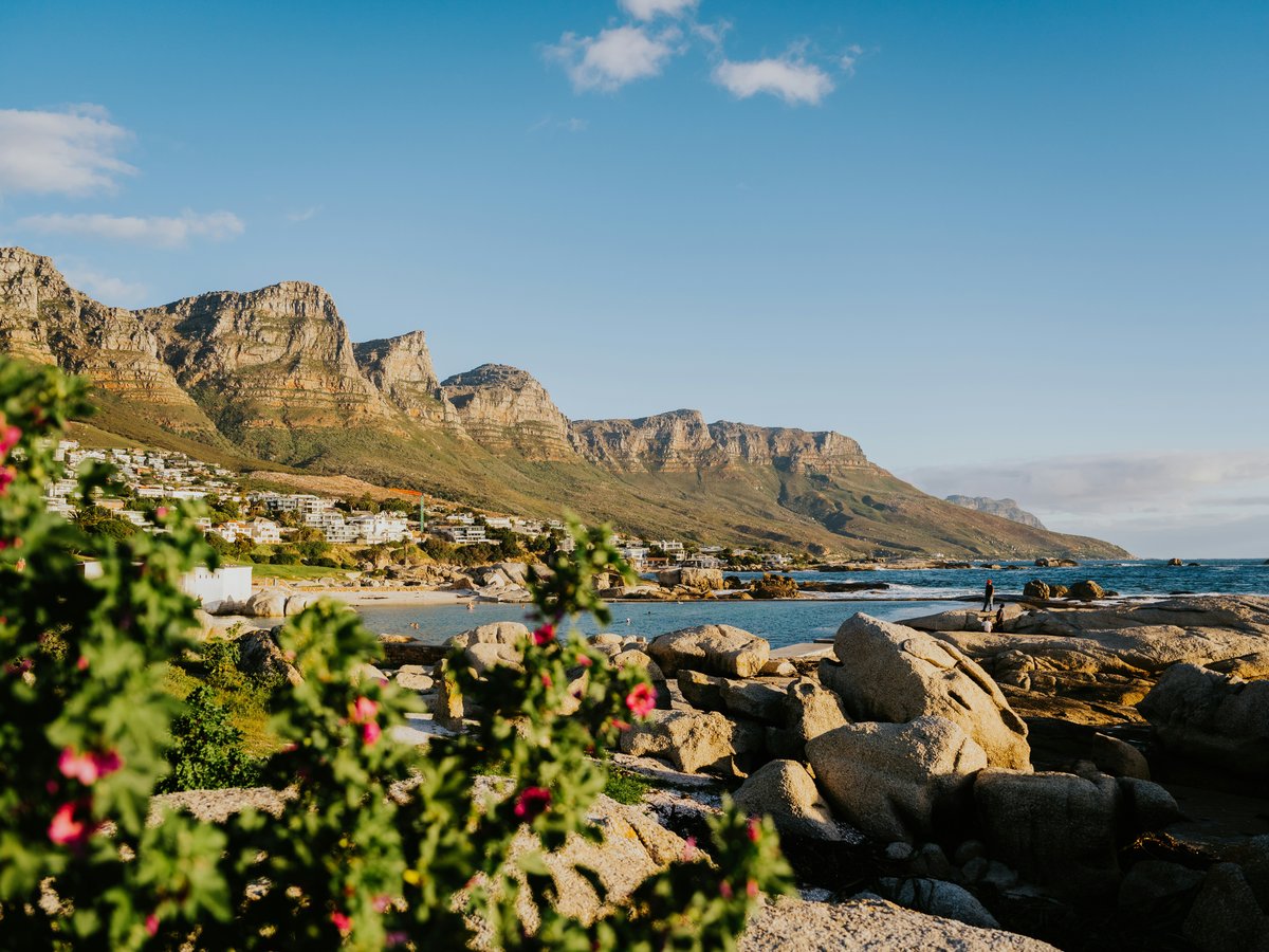 a view of a beach with mountains in the background