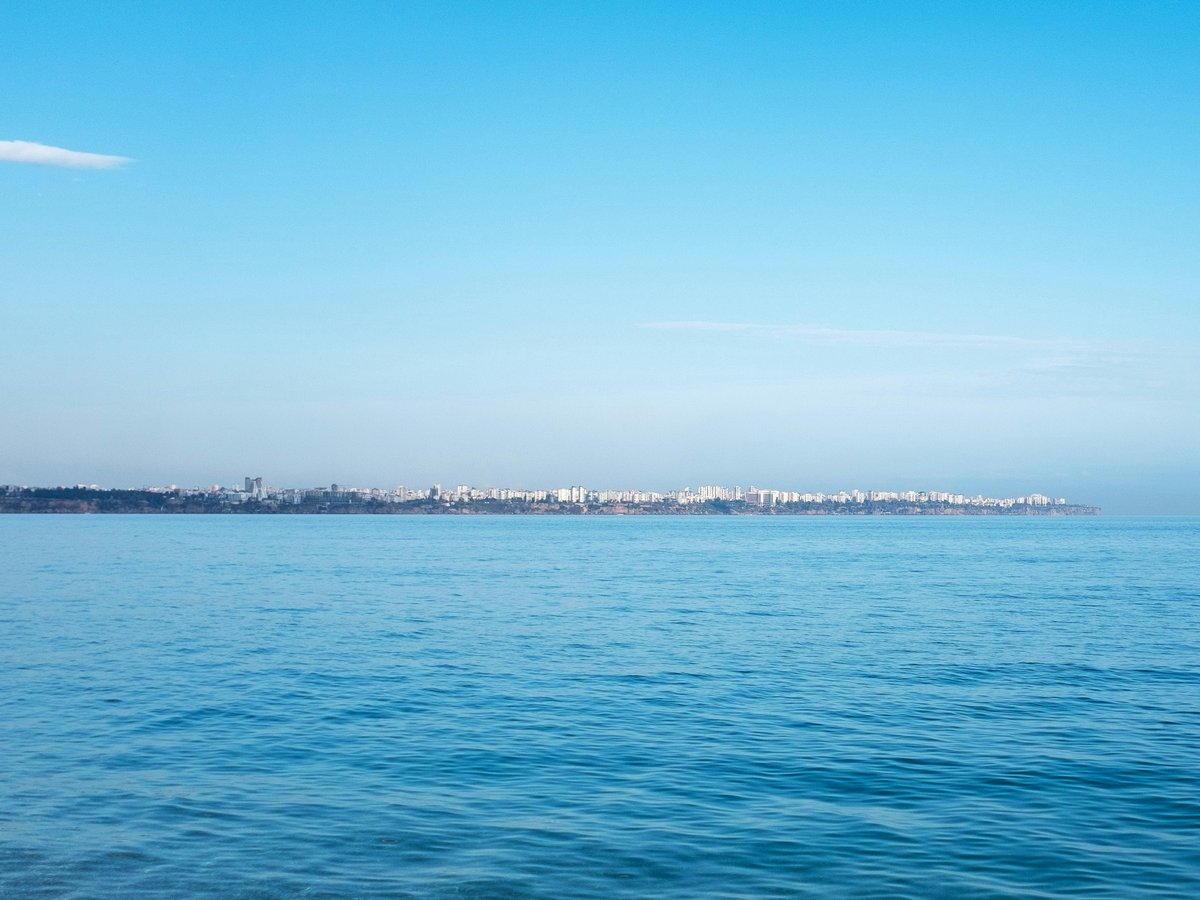 a body of water with a city in the distance
